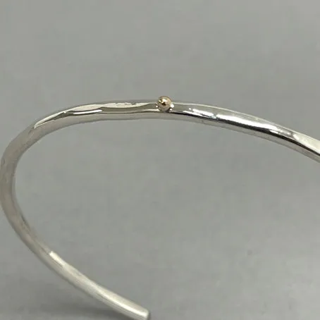 Open silver bangle - gold dot